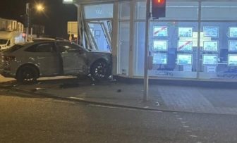 Car smashes into estate agency